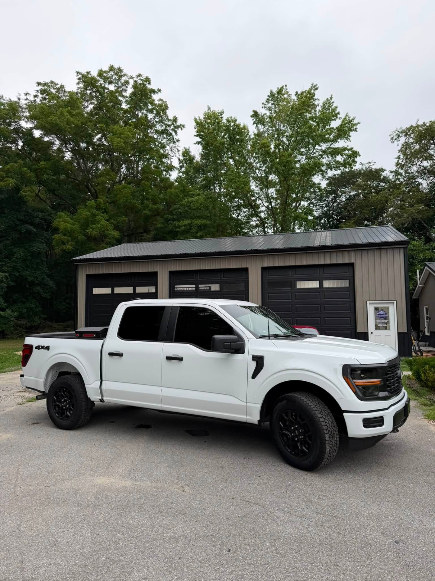 White Ford F-150 pickup truck with 15% ceramic window tint and sunstrip installed by Venom Films in Felton, Delaware